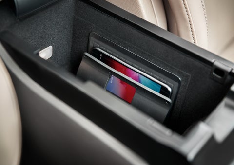 A smartphone device is securely tucked into the available wireless charging pad for an effortless energy boost | Performance Lincoln Bountiful in Bountiful UT