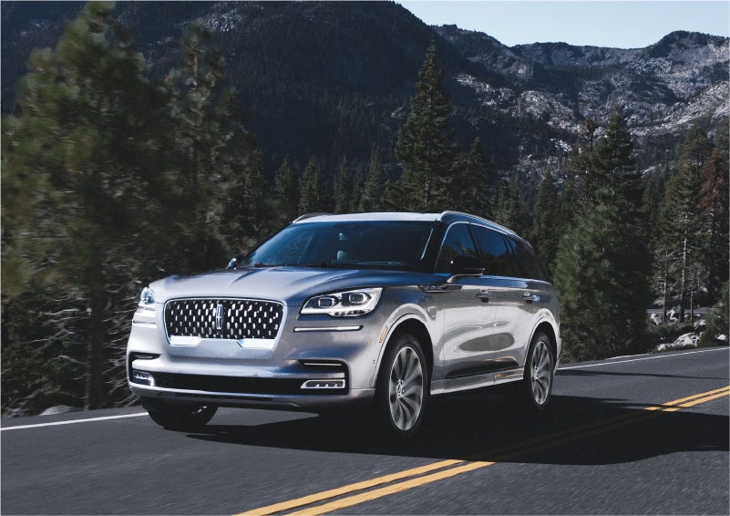 A 2023 Lincoln Aviator® Grand Touring SUV being driven on a winding road to demonstrate the capabilities of all-wheel drive | Performance Lincoln Bountiful in Bountiful UT