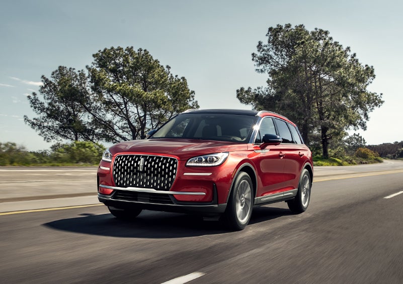 A 2024 Lincoln Corsair® SUV is shown being driven on a country road. | Performance Lincoln Bountiful in Bountiful UT