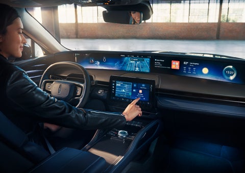 The driver of a 2024 Lincoln Nautilus® SUV interacts with the center touchscreen. | Performance Lincoln Bountiful in Bountiful UT