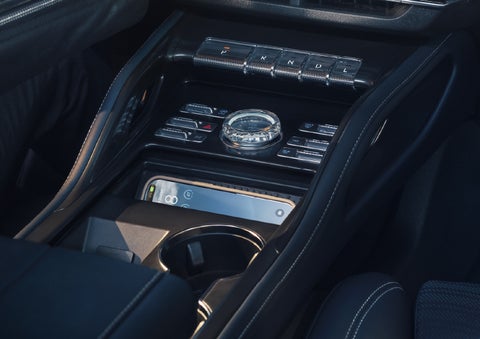 A smartphone is shown charging in the wireless charging pad. | Performance Lincoln Bountiful in Bountiful UT